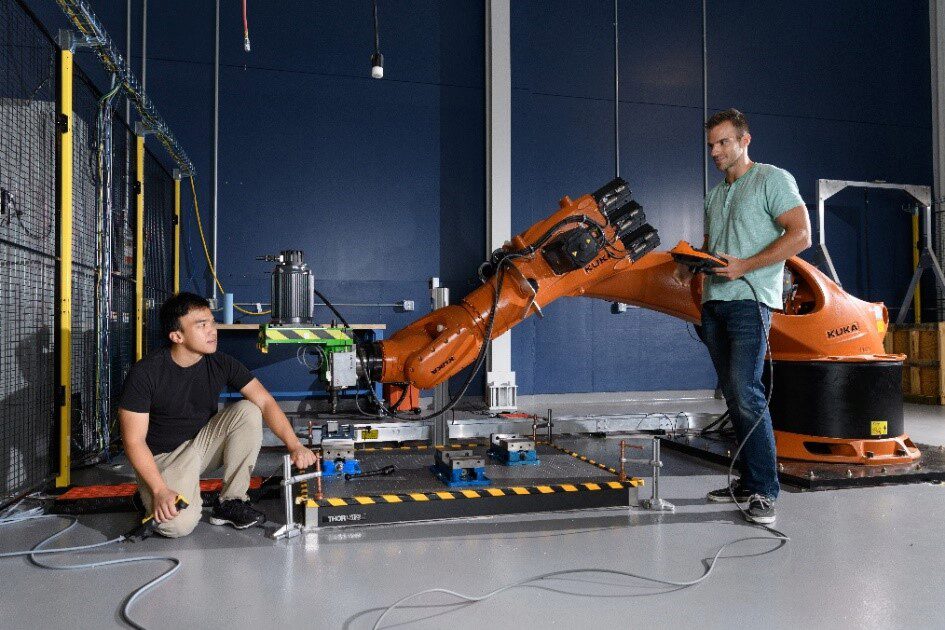 Toni Cvitanic (right) and Vinh Nguyen (left) with Kuka industrial robot