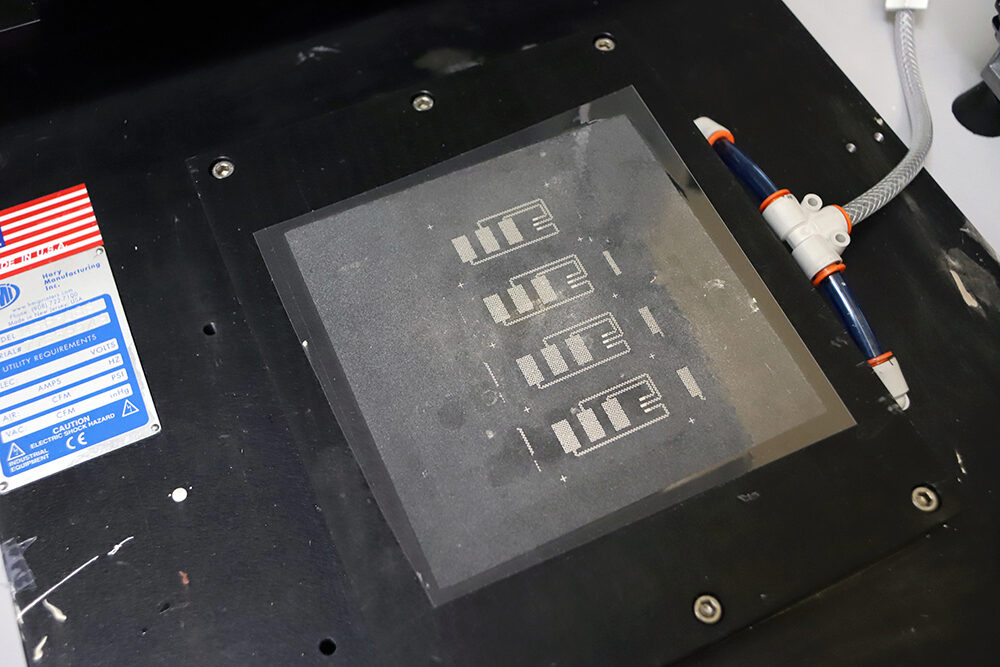 Four screen-printed circuit boards that were manufactured in Yeo's lab.