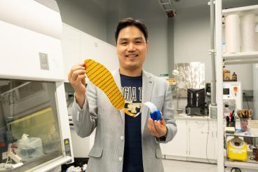 Hong Yeo holds the wearable electronic device made of more than 170 thin, flexible sensors that measure foot pressure — a key metric for determining whether someone is off-balance.