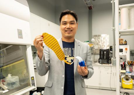 Hong Yeo holds the wearable electronic device made of more than 170 thin, flexible sensors that measure foot pressure — a key metric for determining whether someone is off-balance.