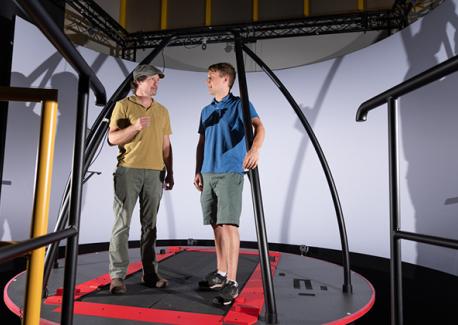 Greg Sawicki and Pawel Kołyski in the Huma PoWeR Lab with a project that measures stability in treadmill walking.