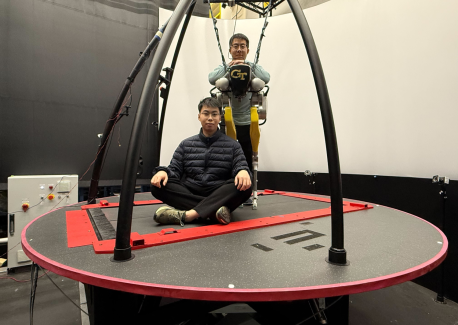 Yipu Chen (seated) and Zhaoyuan Gu (standing) on the CAREN treadmill system